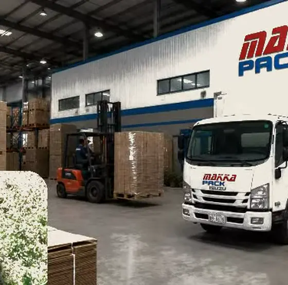 Two delivery trucks loading inside the finished-goods store.
